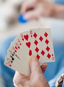 a person holding playing cards playing a game