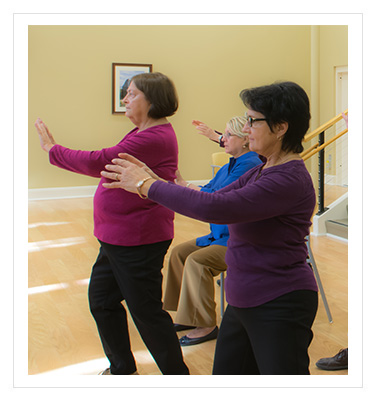 a group of women performing tai chi